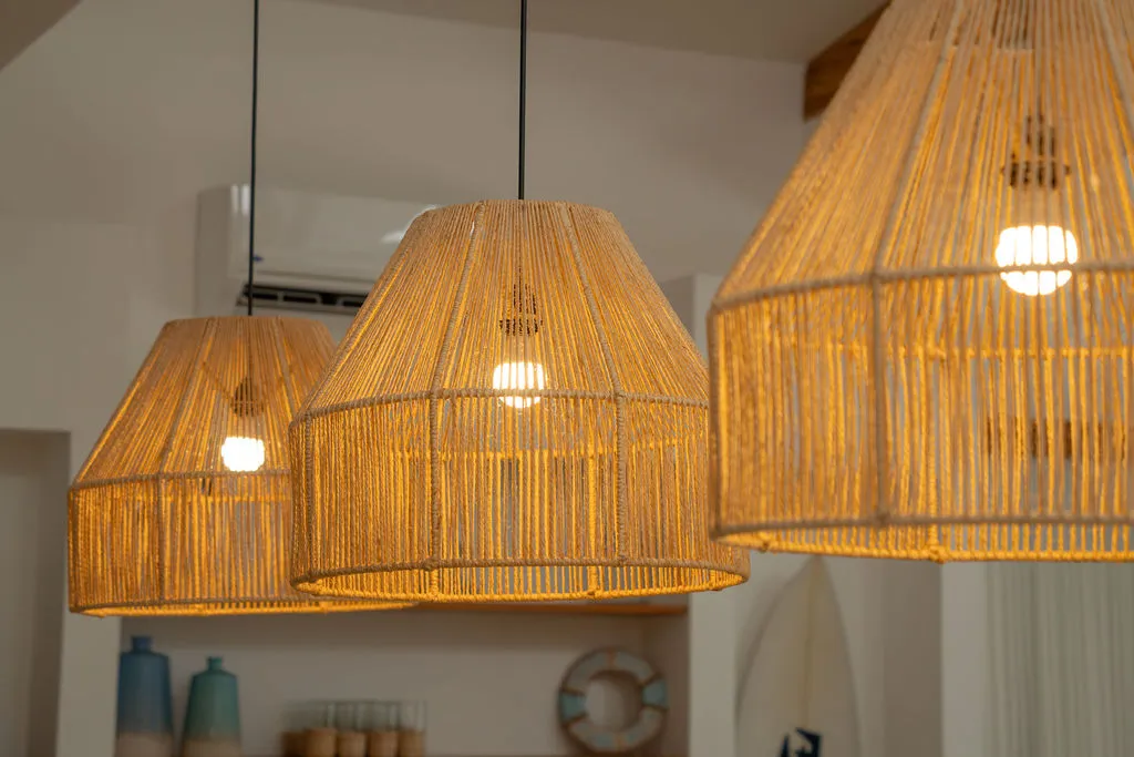 Three woven rattan pendant lights hanging above the kitchen counter